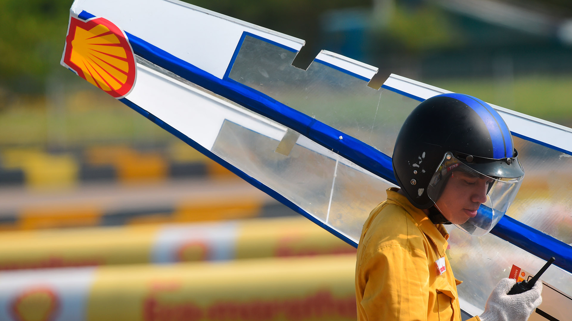 Photo from 2010 Shell Eco-marathon in Asia - a student holding a car part