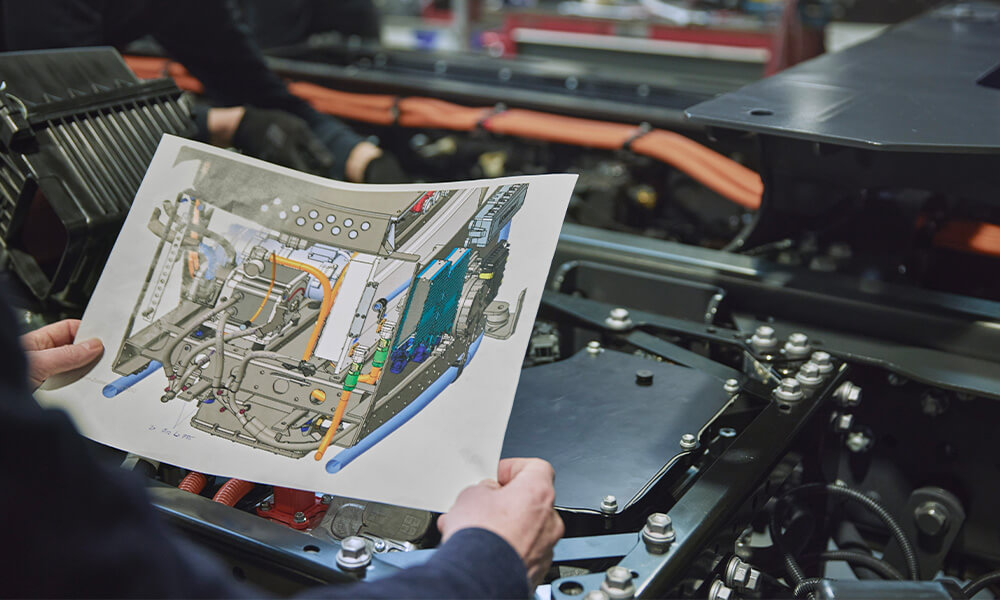 Person plugging hydrogen fuel lead into vehicle
