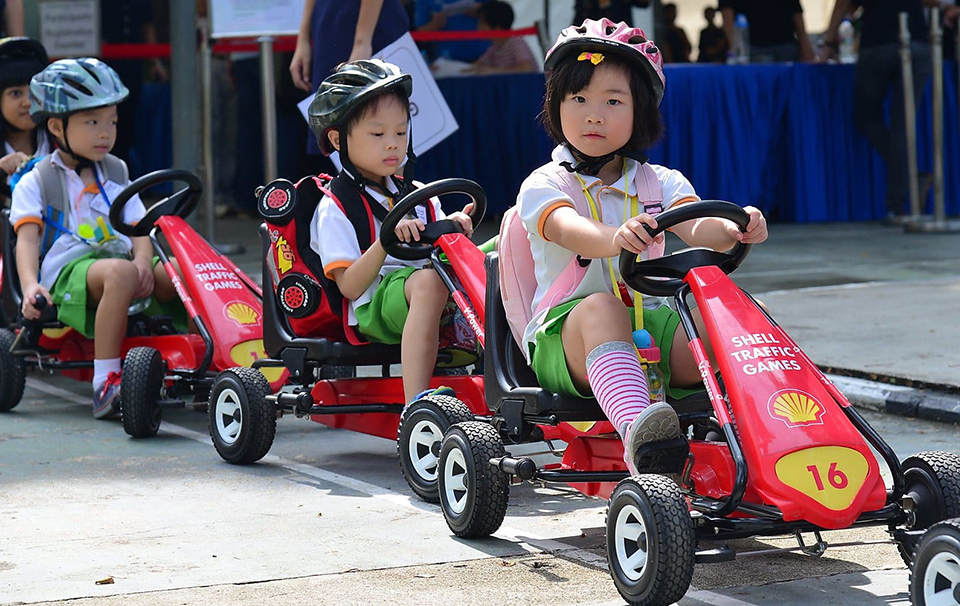 Children pedalling on go-karts