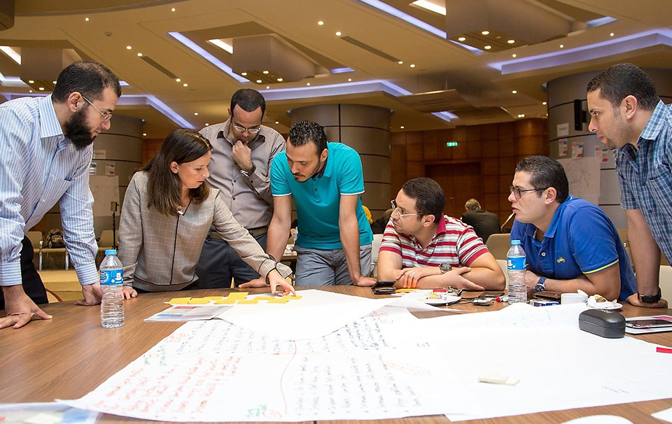 Group of people studying items on table