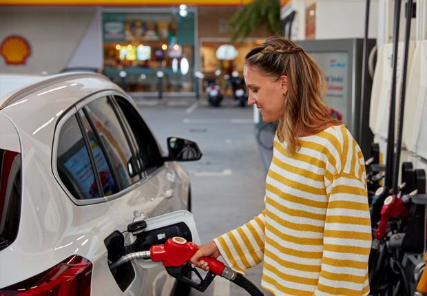 photo of a man filling up at petrol station